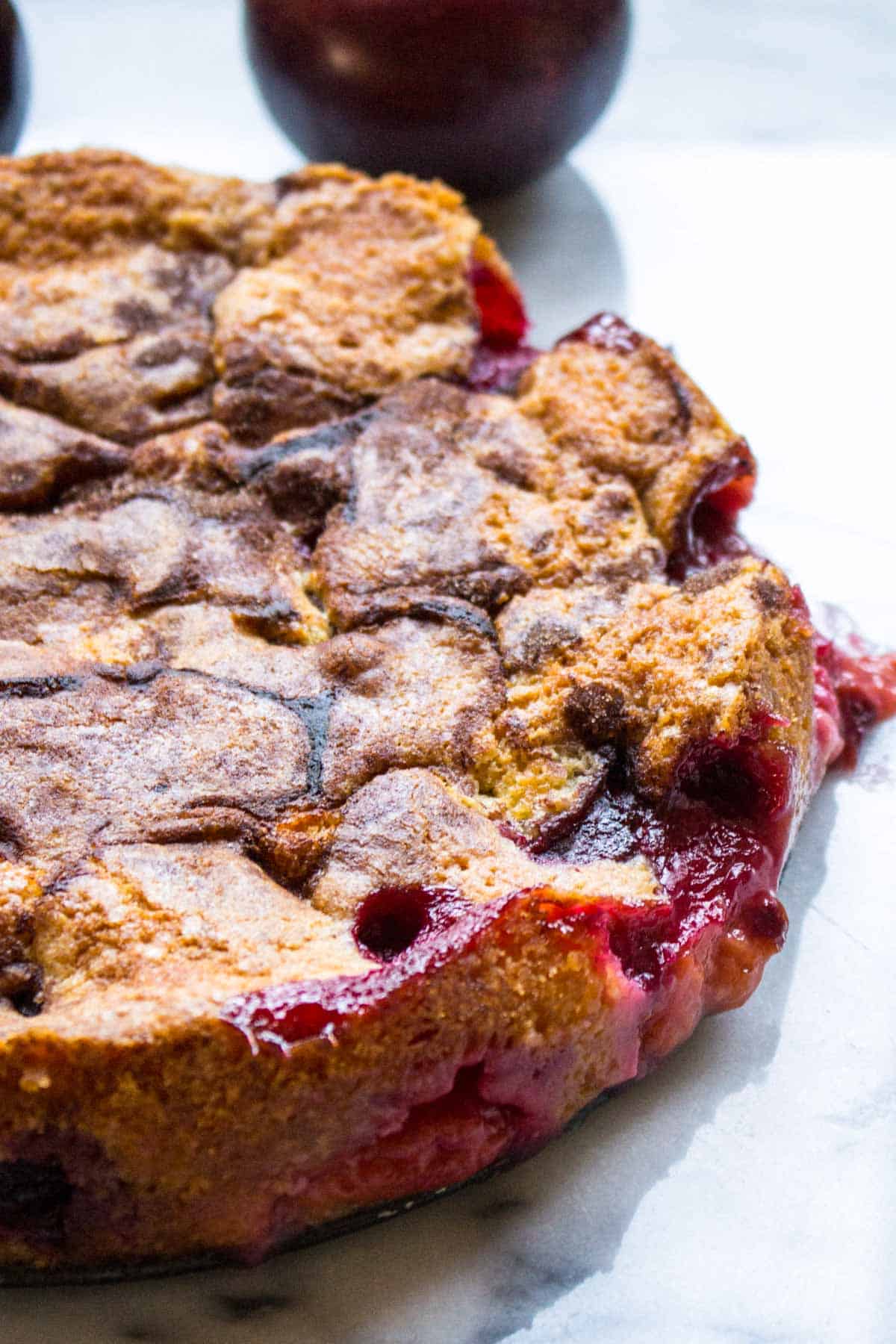 A whole cake with jammy fruit throughout.
