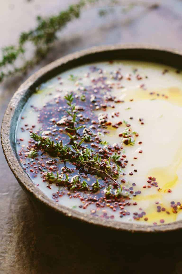 Bowl of parsnip cauliflower soup made with quinoa.