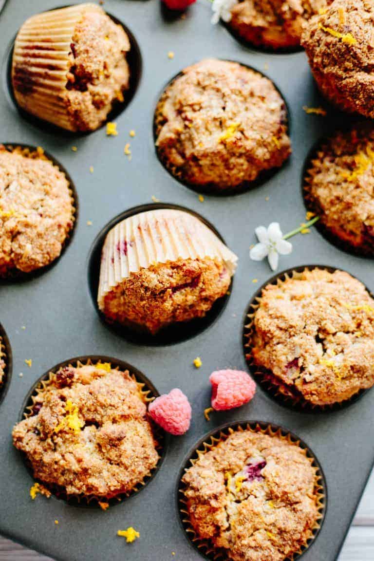 Close up of Paleo orange raspberry muffins baked in a muffin tin.