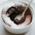Close up of a bite of chocolate souffle on a teapsoon.