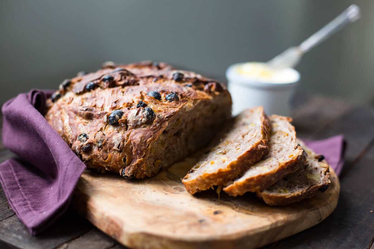 side view of a sliced loaf of cinnamon raisin walnut bread