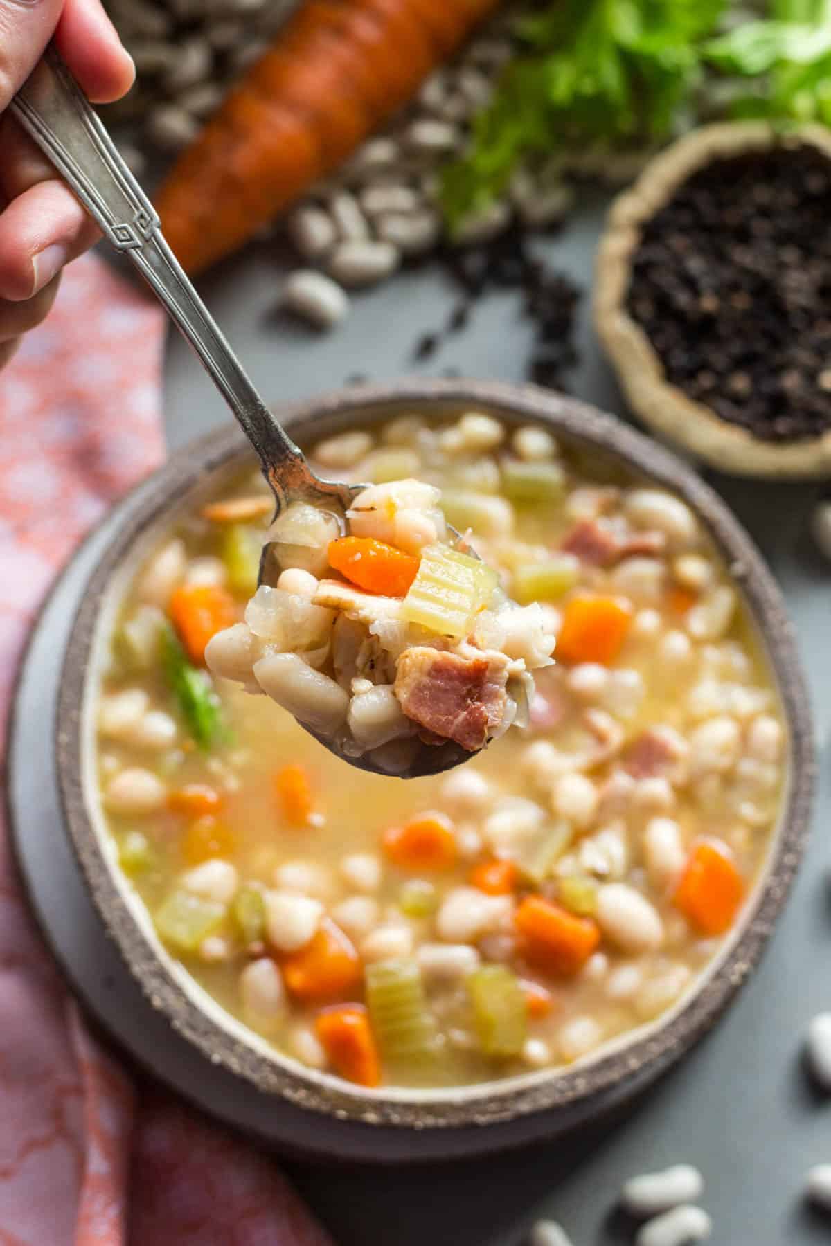 overhead shot of a spoon full of bean soup