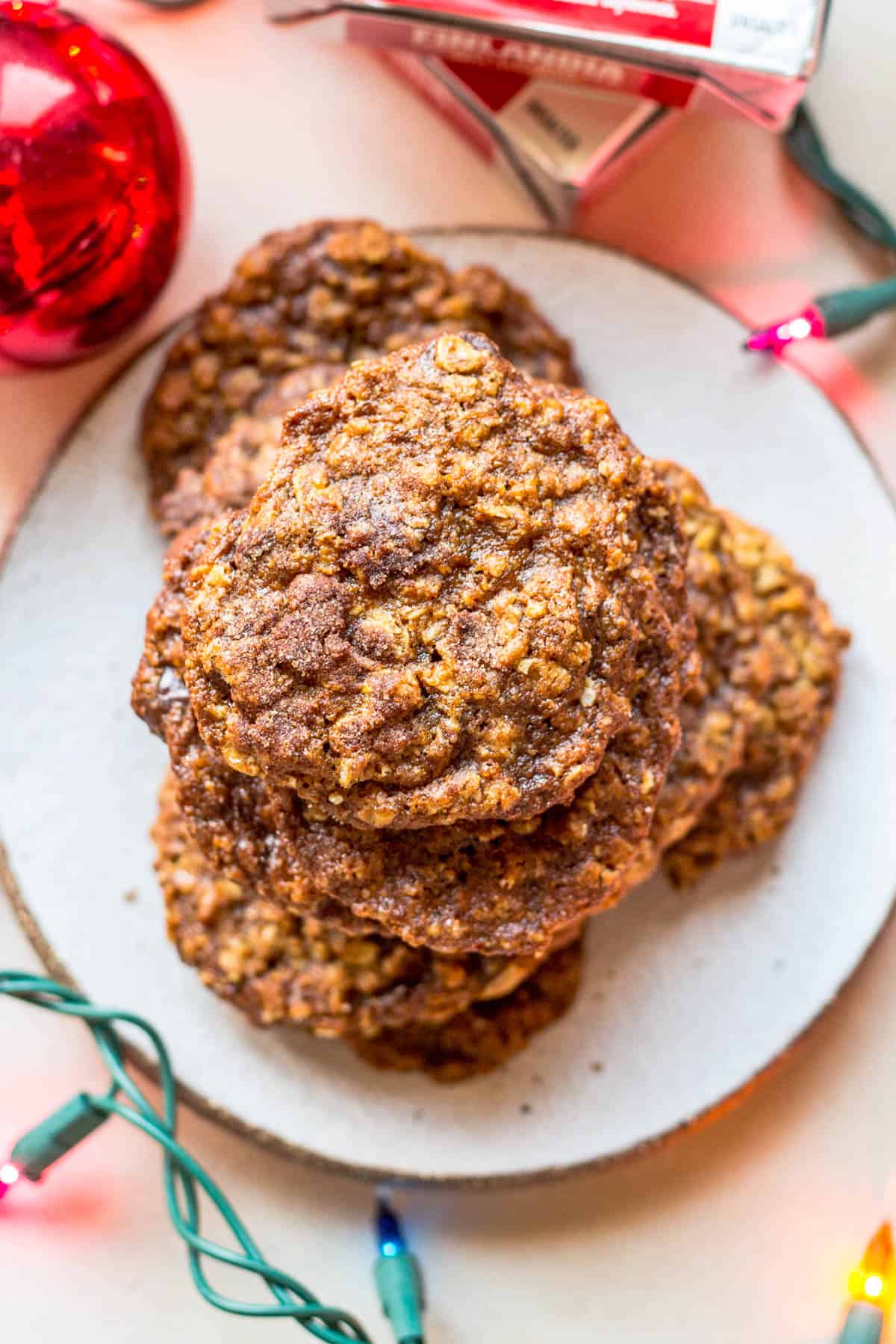 top view of a plate of oatmeal chocolate chip cookies with Christmas lights