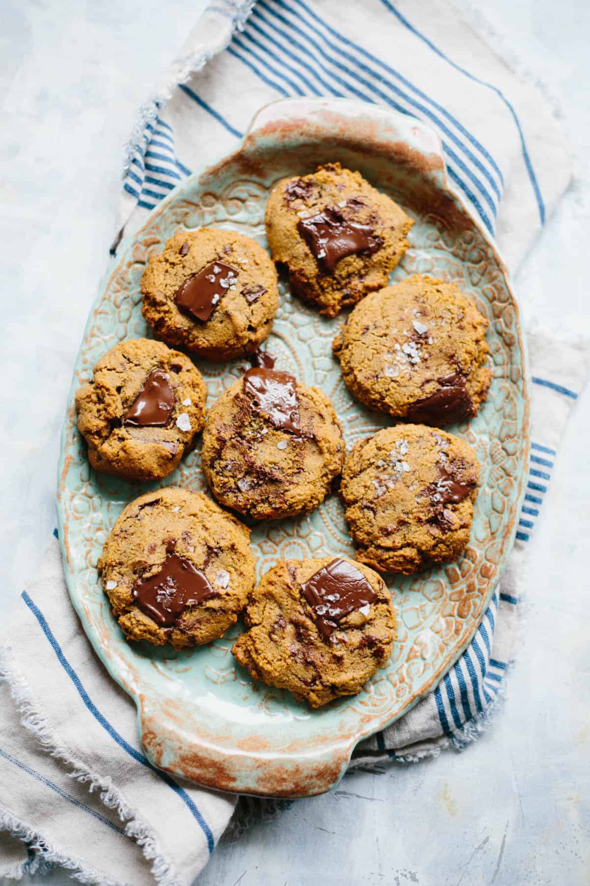 Close up of an oval stoneware platter filled with Paleo chocolate chip cookies.