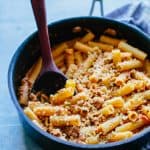 A pan with Rigatoni and a wooden spoon sticking out
