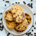 overhead shot of plate of chocolate chip shortbread cookies with espresso beans scattered around