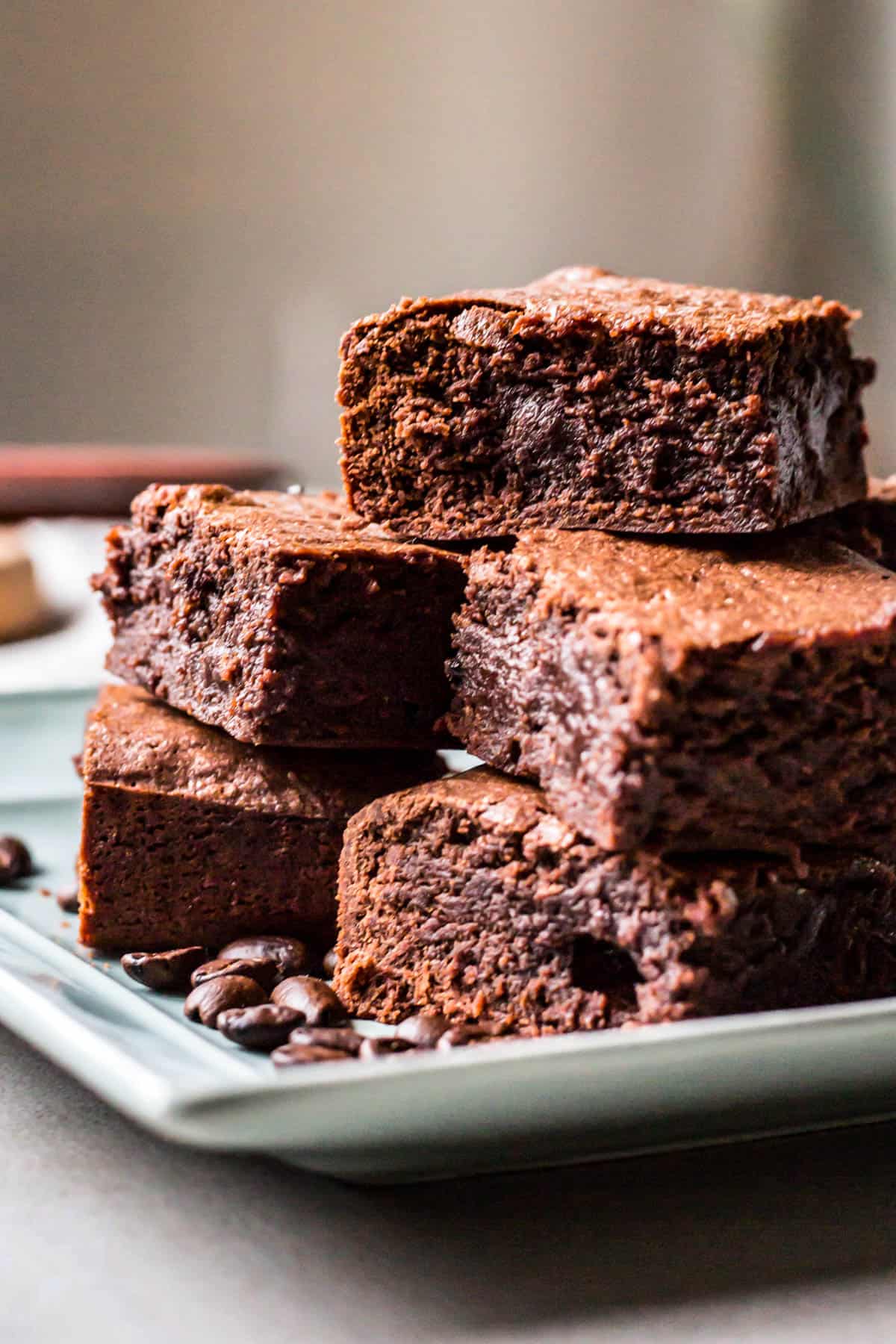 side view of a blue plate with brownies stacked on it