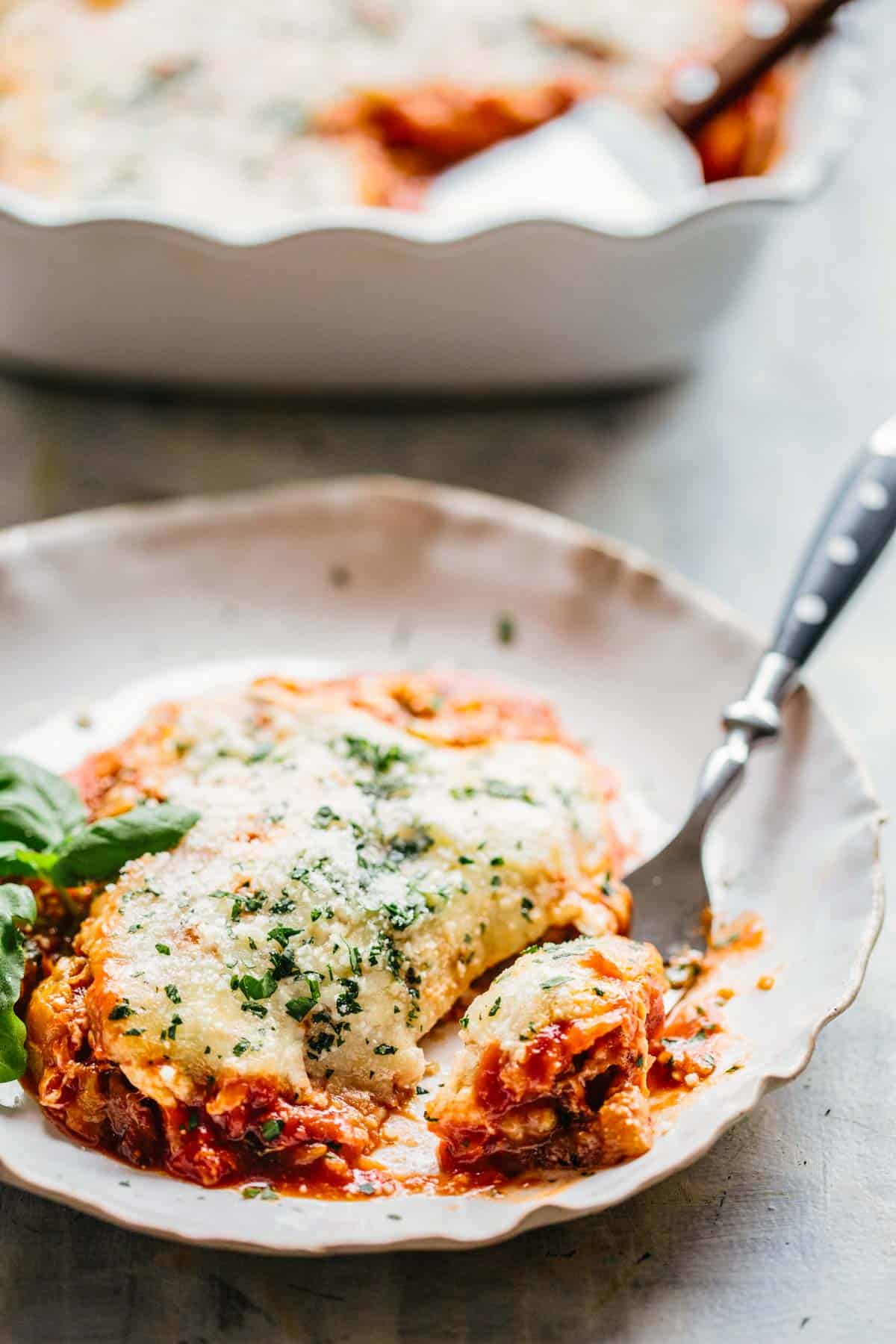 a plate of baked eggplant casserole with a fork