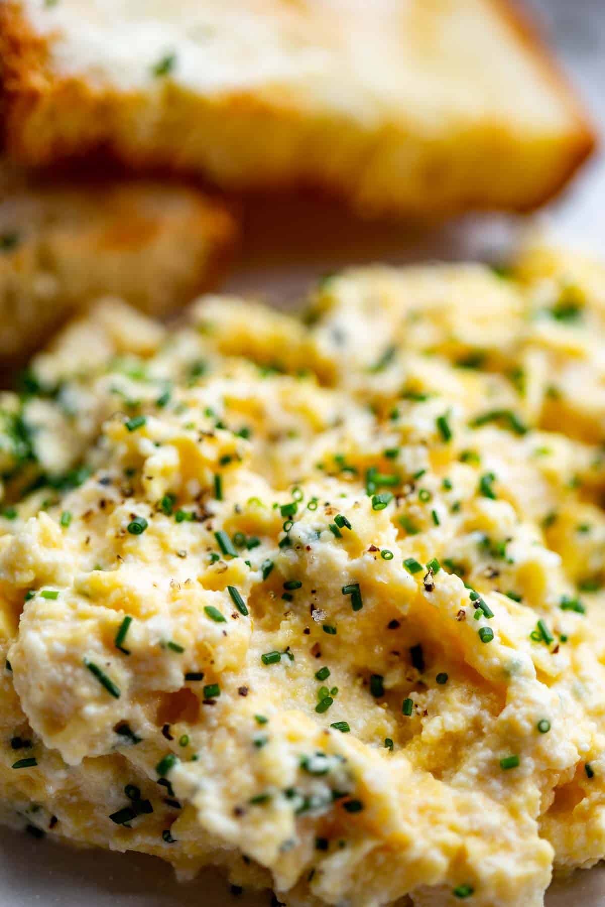 extreme close up of scrambled eggs with herbs on top