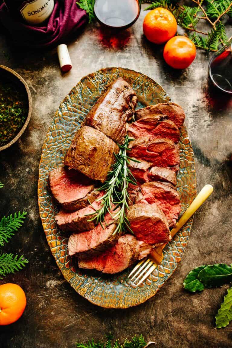 Overhead shot of a platter of sliced beef tenderloin.