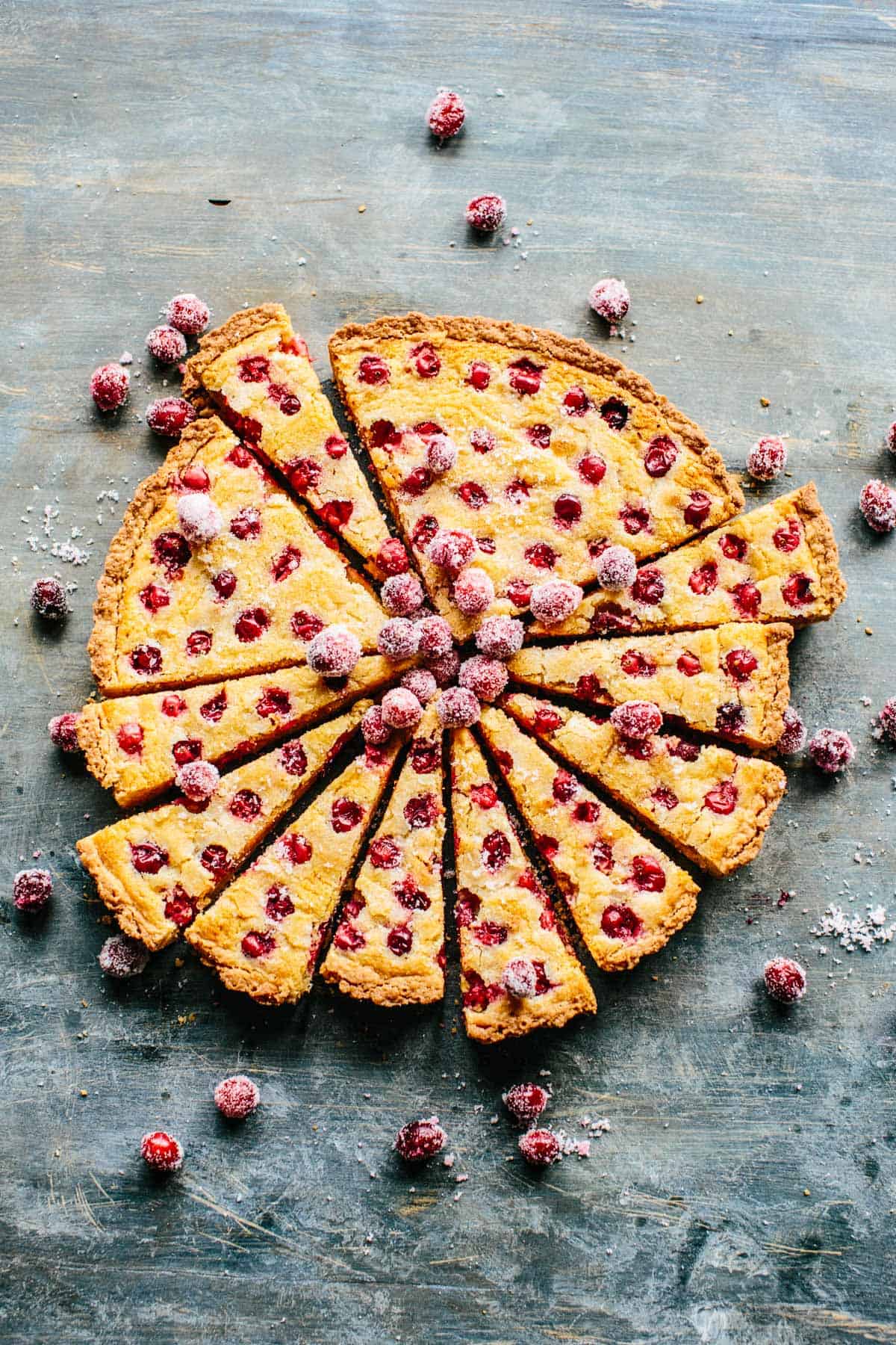Overhead shot of a sliced tart with cranberries dotted throughout.