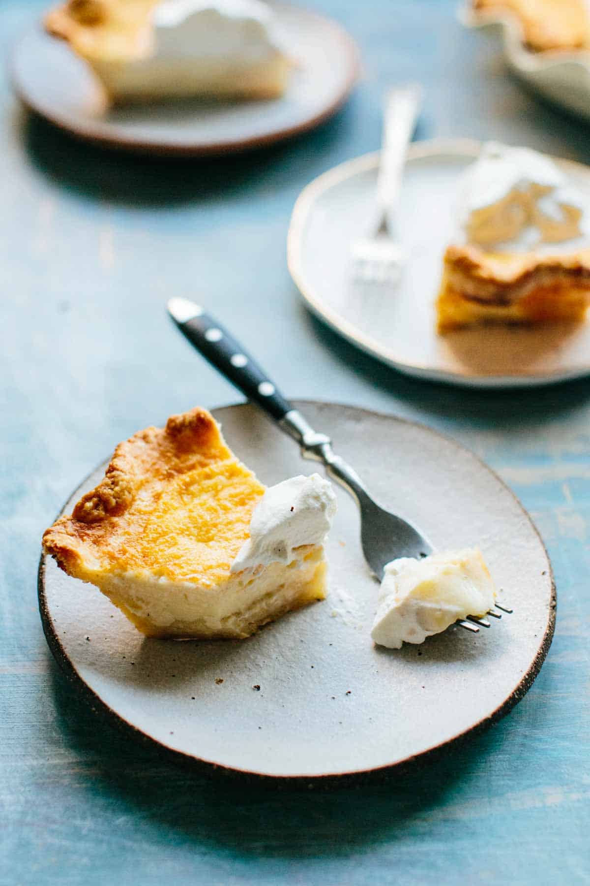 a slice of pie on a white plate with a bite taken out of it.