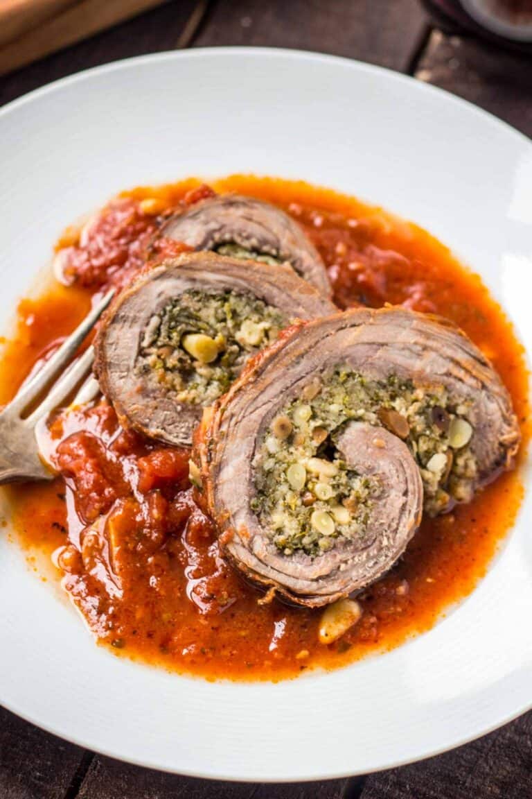 beef braciole sliced in a bowl with sauce