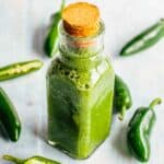 A corked bottle of jalapeño hot sauce.