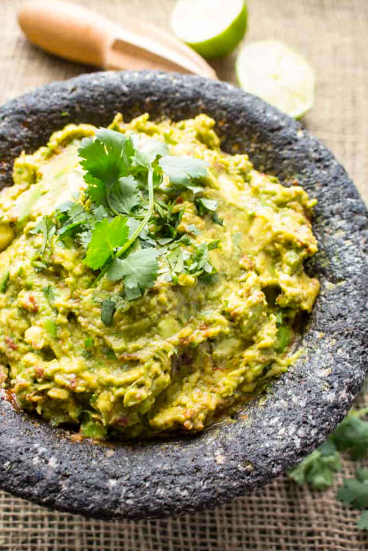 A molcajete of guacamole garnished with cilantro.