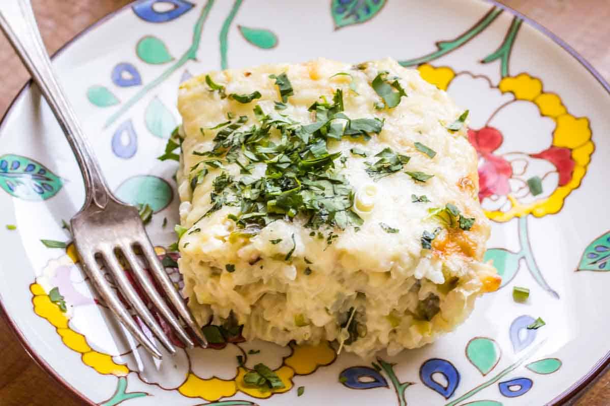 Close up of a corn and rice casserole garnished with chopped cilantro.