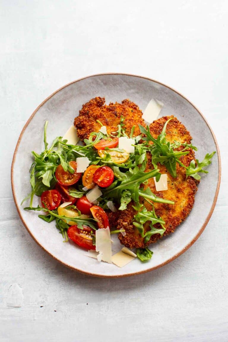 chicken Milanese served with a tomato arugula salad