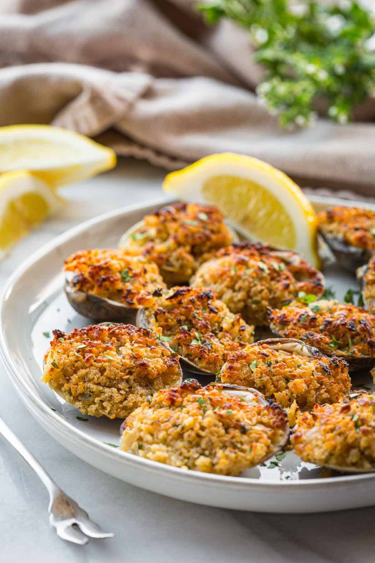 Homemade clams oreganata served with lemon slices.