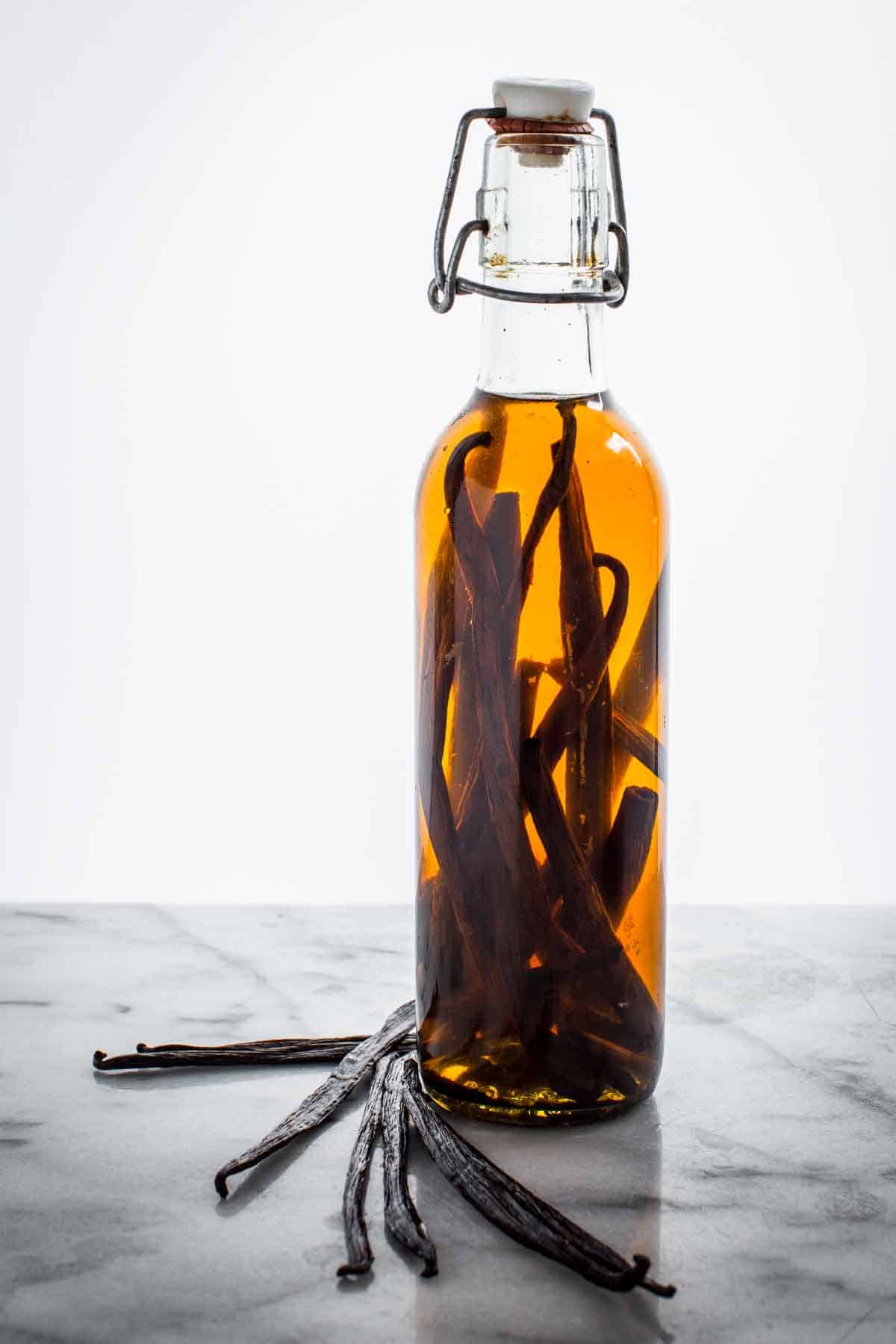 Glass bottle filled with vanilla extract.