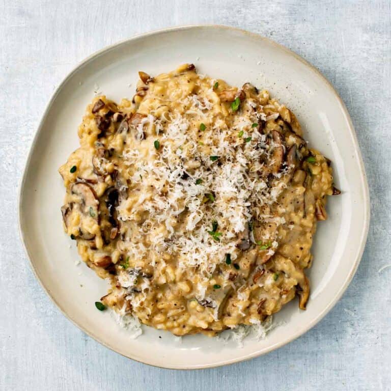 Creamy mushroom risotto topped with freshly shredded cheese.