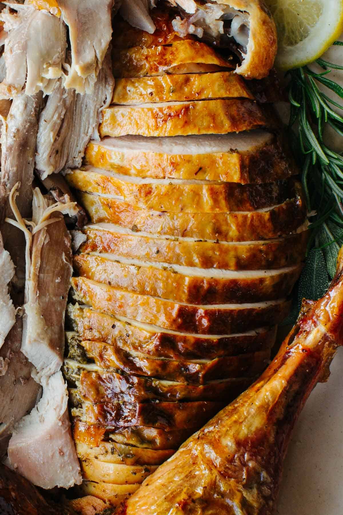 Perfectly carved turkey, rosemary and lemon slices.