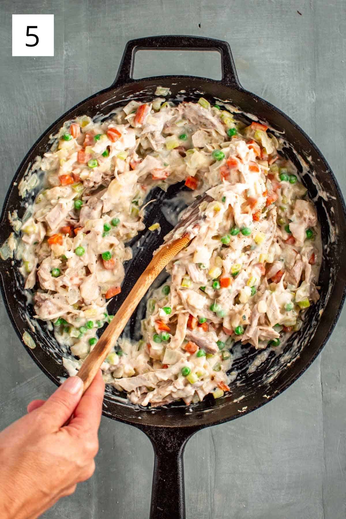 Stirring the filling for turkey pot pie.
