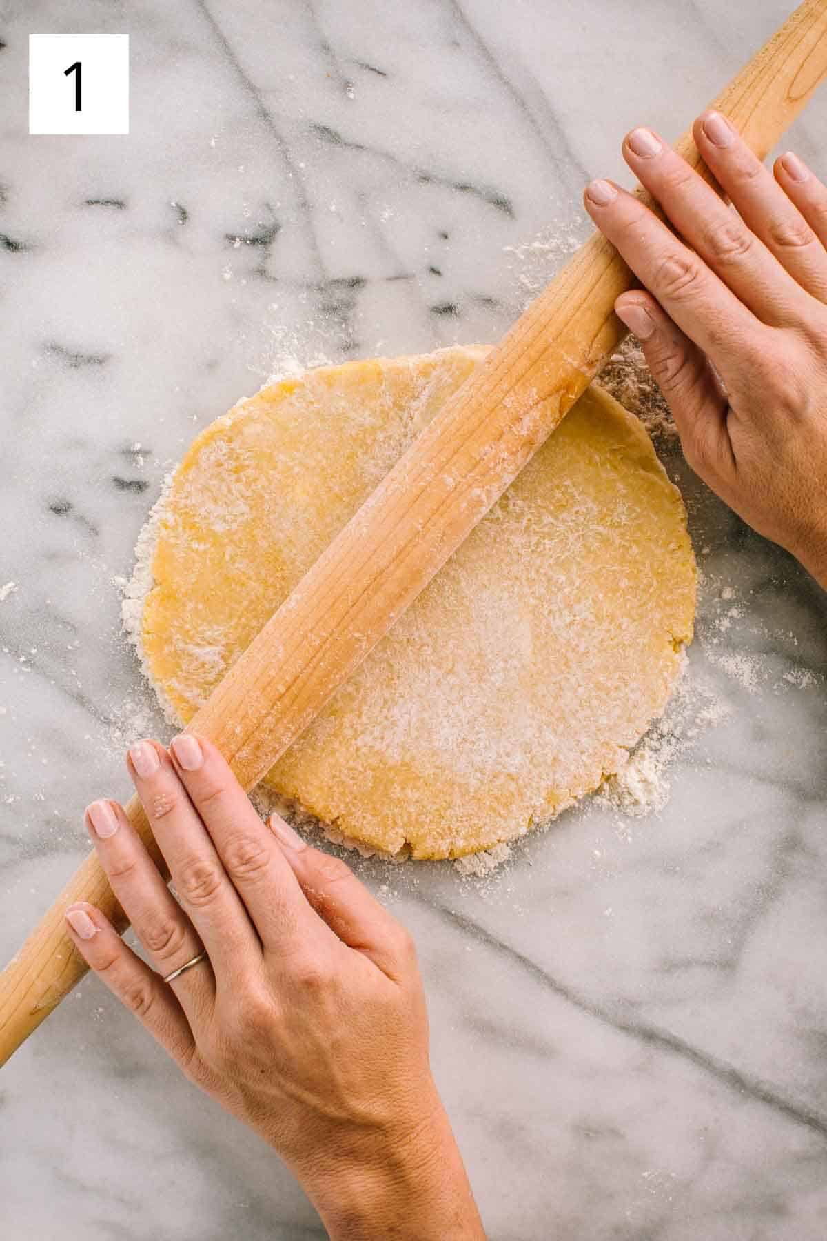 Rolling out dough on a marbled surface.