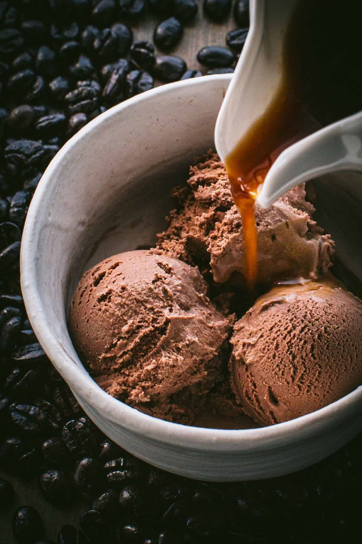 Pouring hot espresso over chocolate gelato.