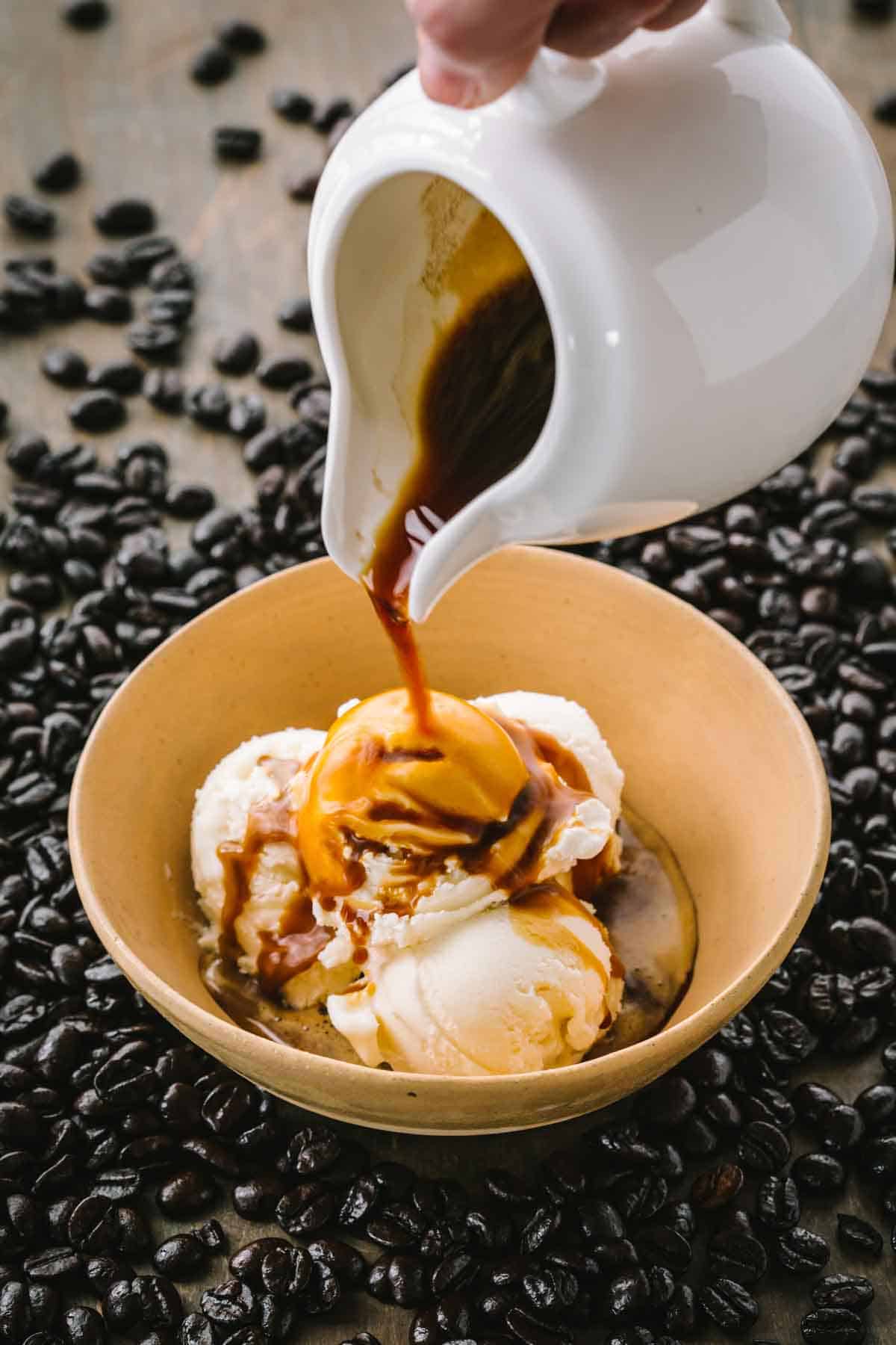 Pouring espresso into a bowl of Italian affogato gelato.