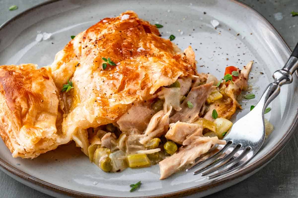 A piece of turkey pot pie on a plate.