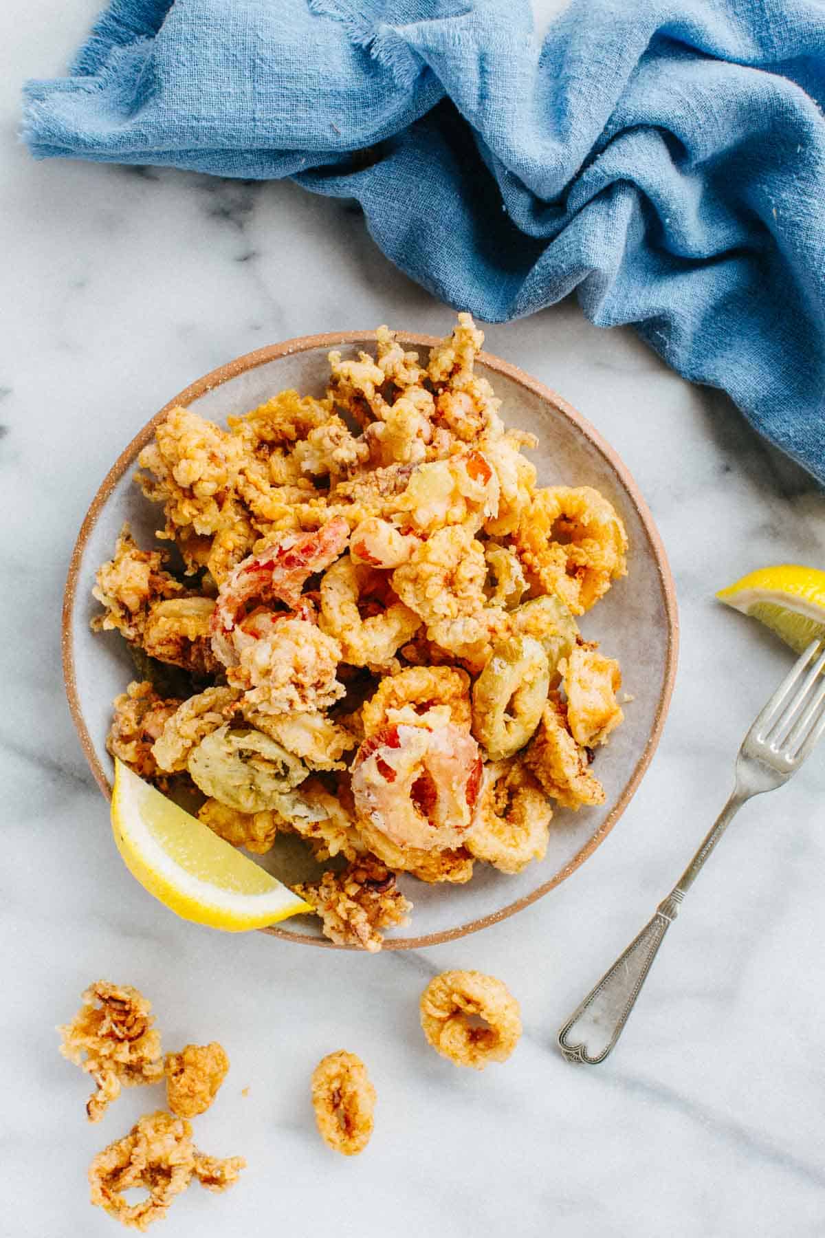 Squid battered and fried and garnished with lemon.