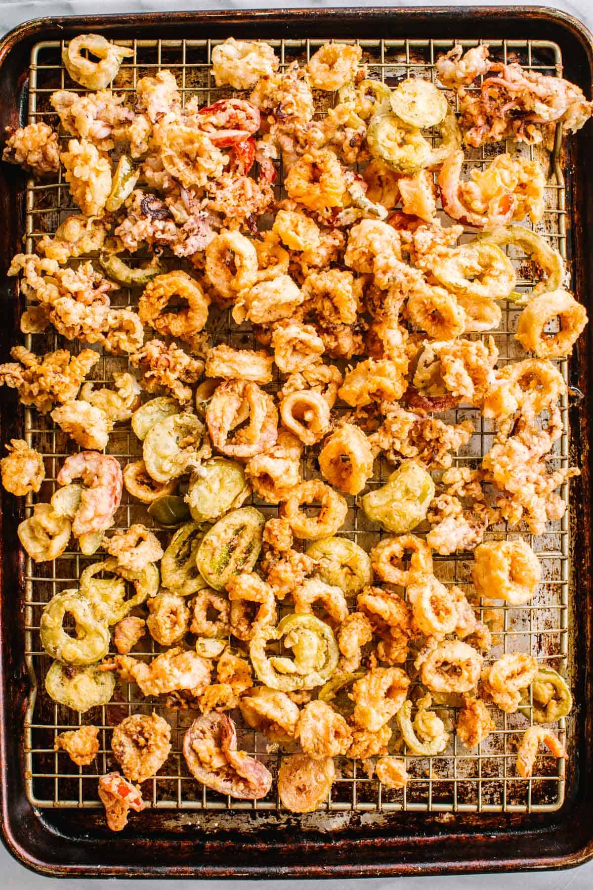 Homemade fried calamari on a sheet pan.