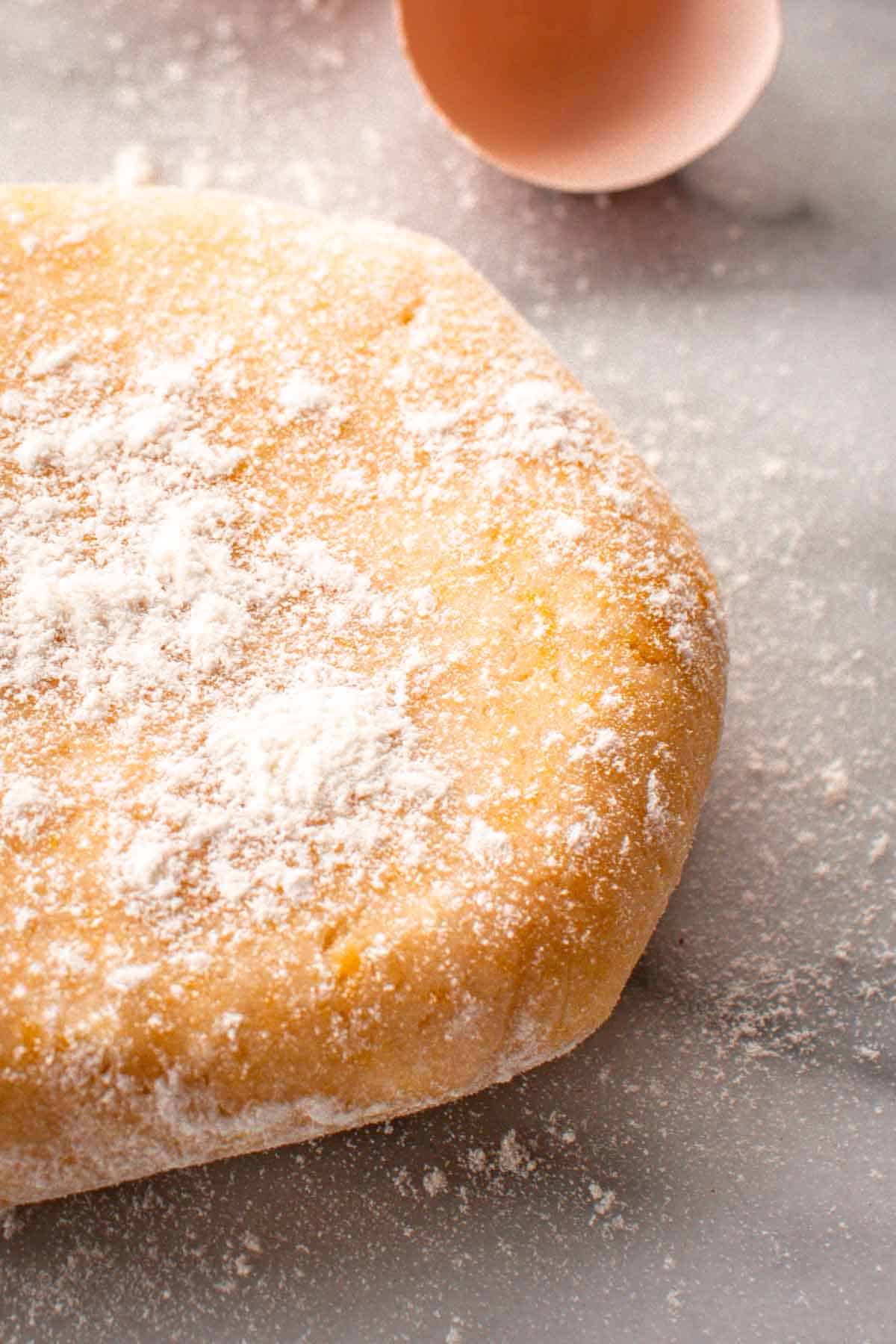 Close up of pasta frill pastry dough with flour sprinkled on top.
