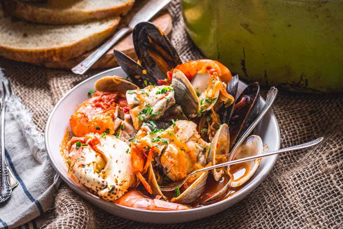 A bowl of shellfish in tomato broth.