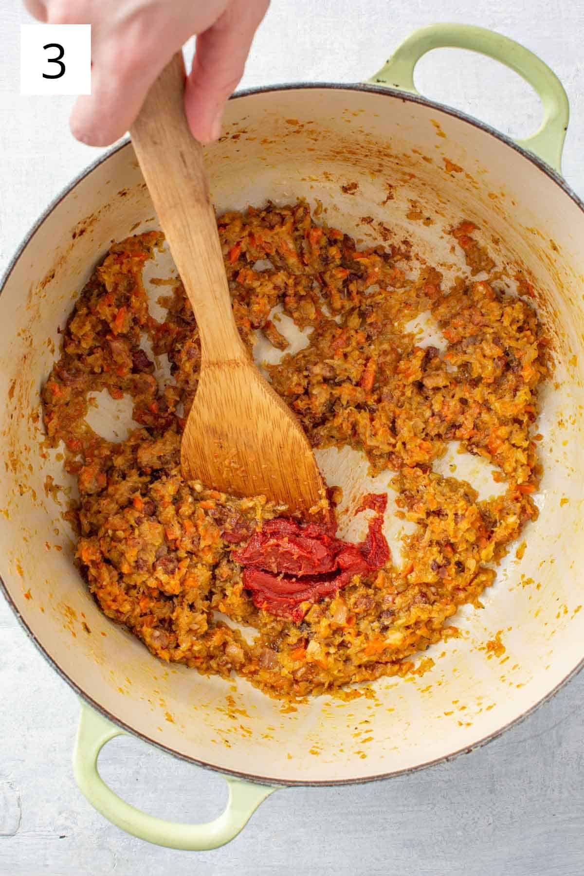 Vegetables added to dutch oven in pasta fagioli recipe.