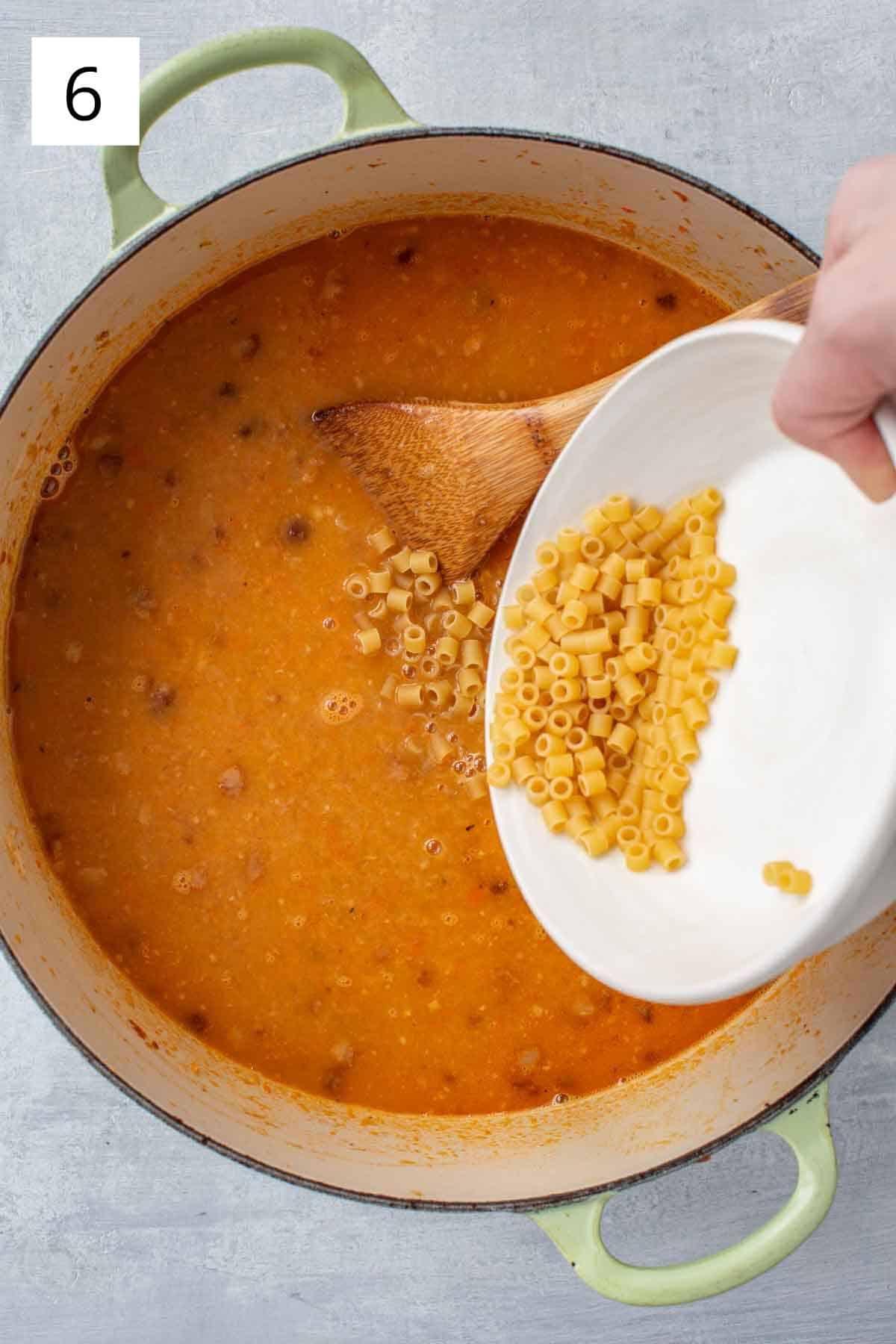 Adding pasta to recipe ingredients.