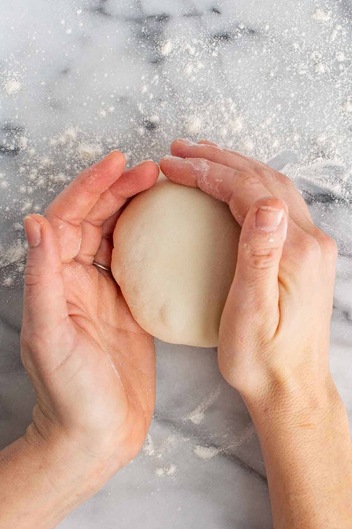 Working with homemade dough on a floured surface.