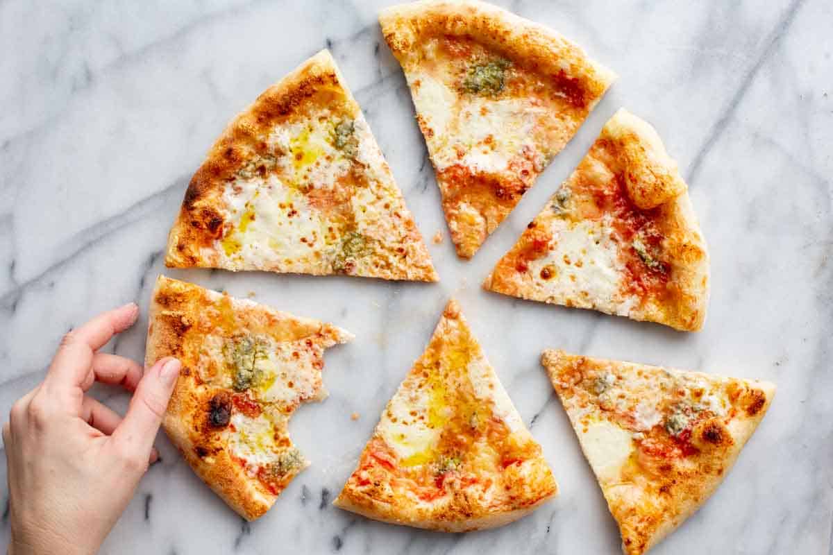 Four cheese pizza cut into slices.
