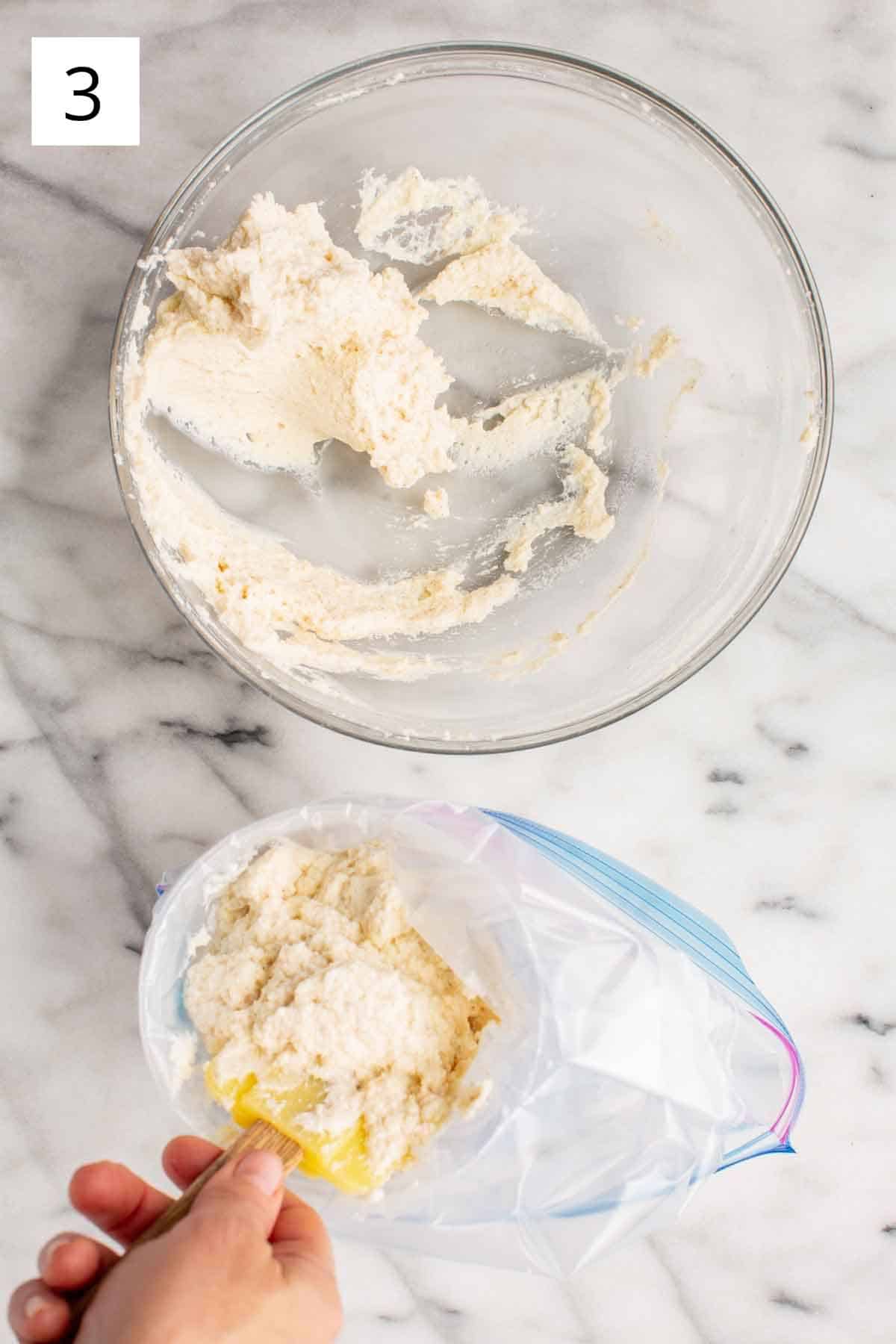 Scraping cannoli cream into a zip top bag.