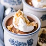 A ramekin with chocolate hazelnut panna cotta and whipped cream.