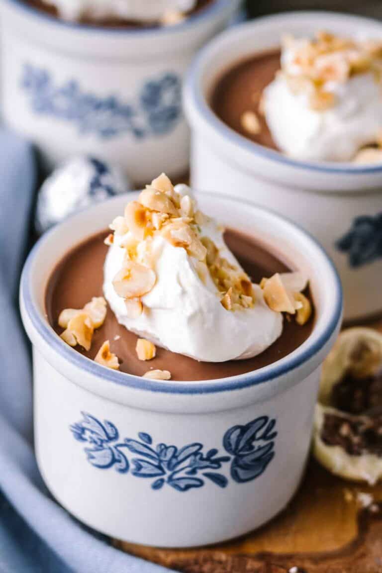 A ramekin with chocolate hazelnut panna cotta and whipped cream.