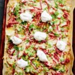 Sheet pan Irish nachos on a parchment-lined baking sheet.