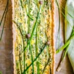 A long rectangular asparagus and goat cheese quiche.