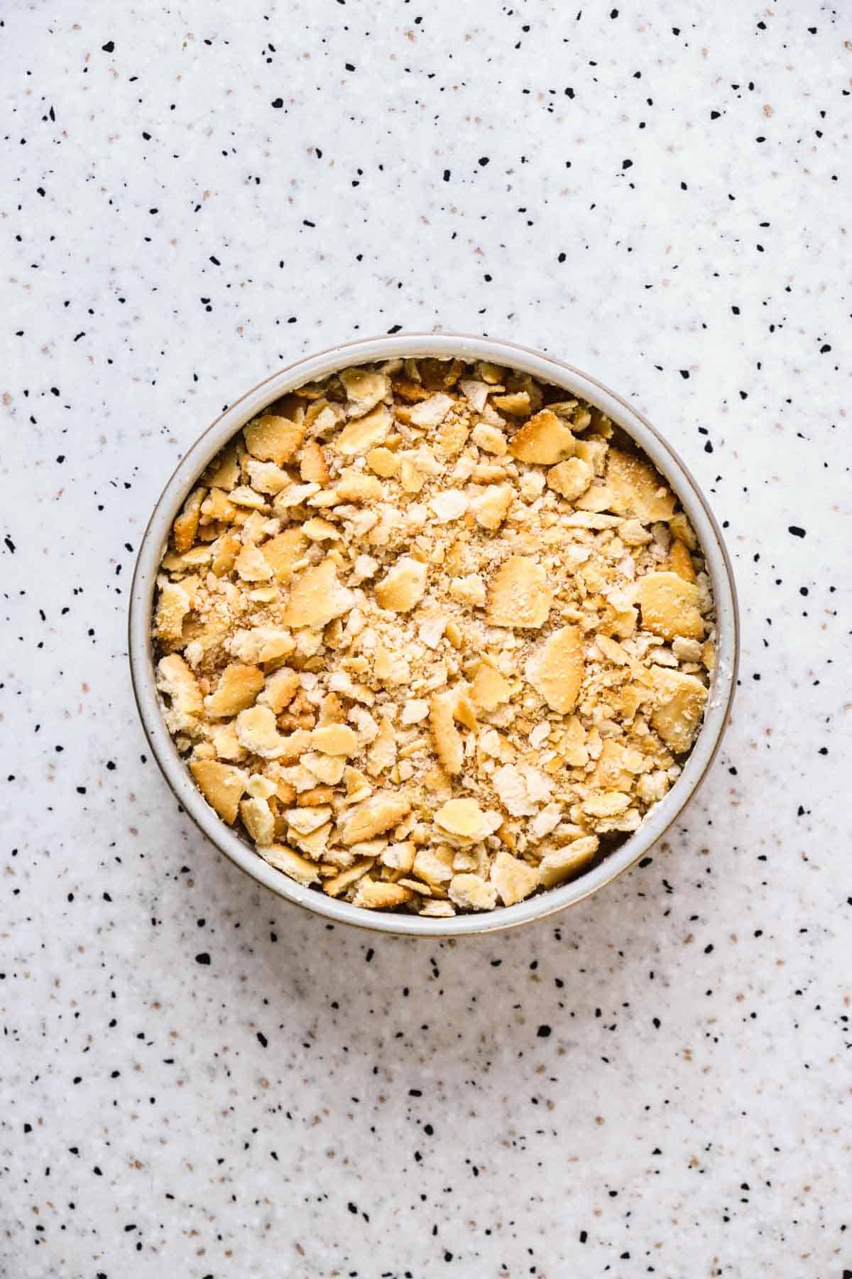 Bacon dip topped with crushed ritz crackers ready to go into the oven.