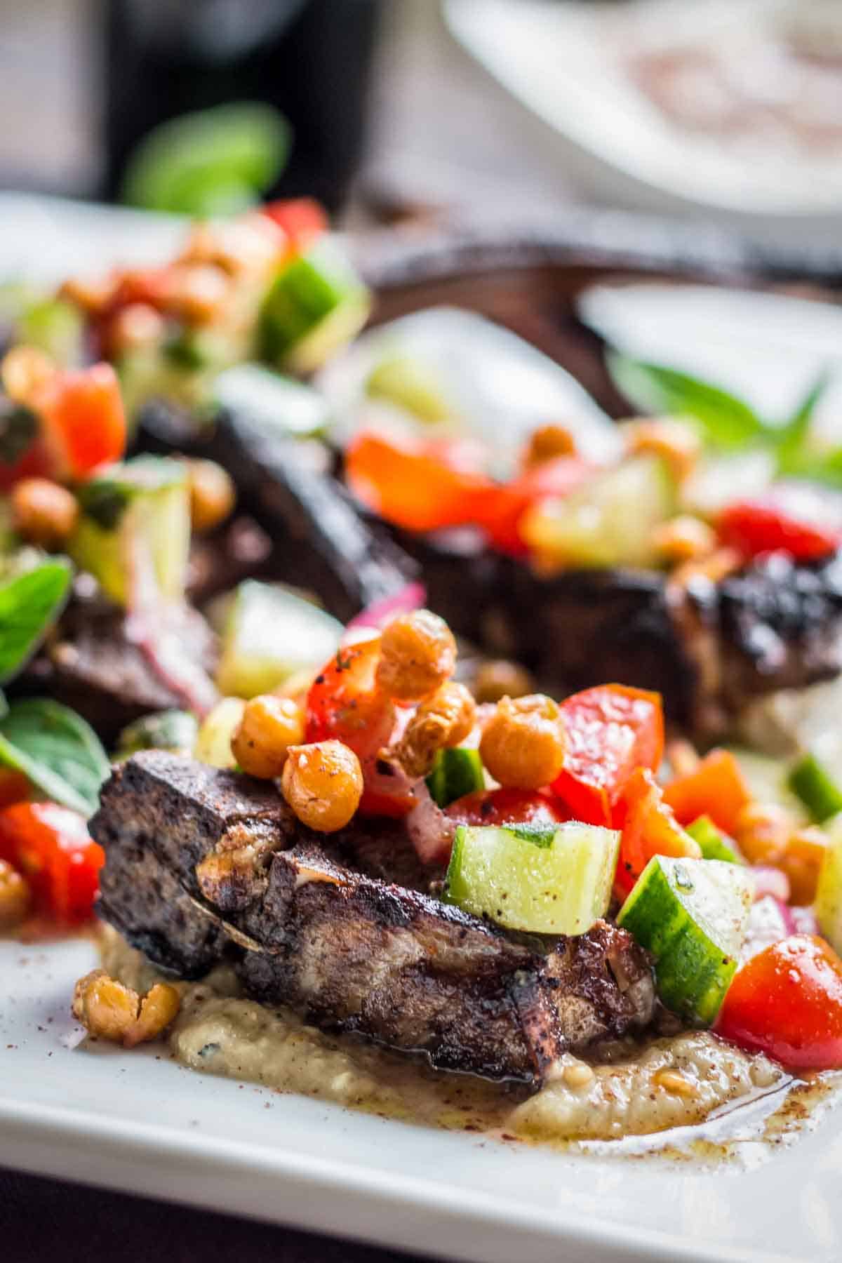 Crispy chickpeas on top of a bone-in lamb chop.