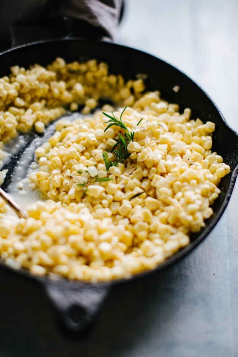 a cast iron pan filled with creamed corn.