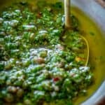 A dish of Italian salsa verde with vibrant green olive oil.