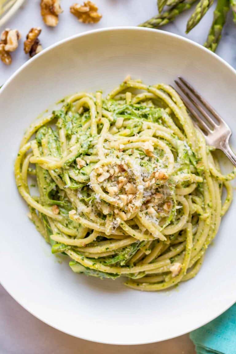 a bowl of spaghetti with shaved asparagus and ramp pesto.