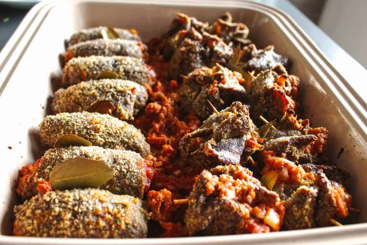 A tray of baked beef spiedini.