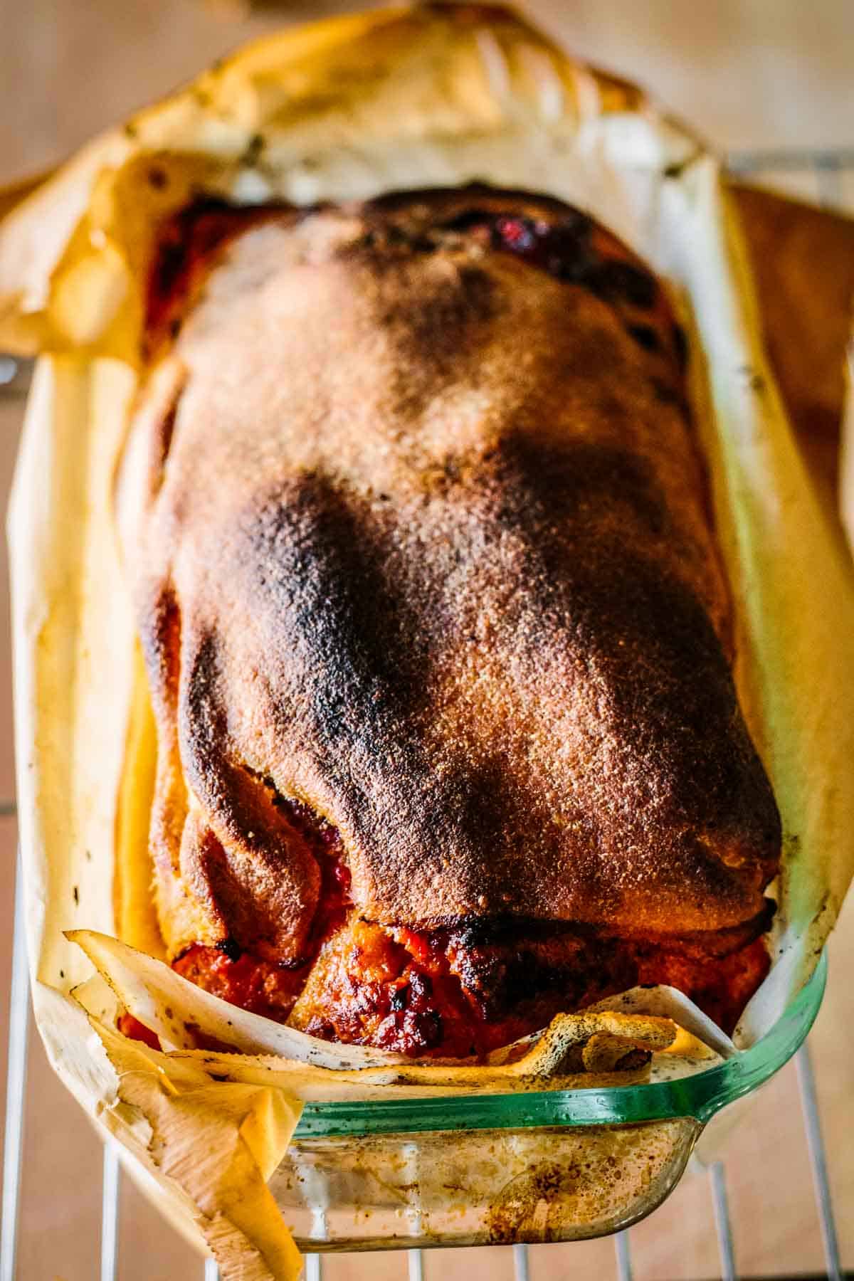 Freshly baked, charred, Scaccia ragusana still in the baking dish.